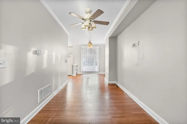 a view of an empty room with wooden floor