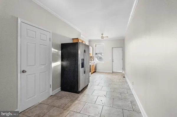 a view of a refrigerator in kitchen and entryway