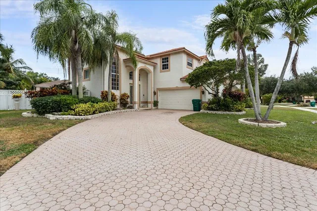 a front view of house with yard and green space