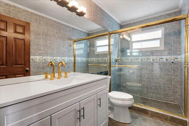 a bathroom with a sink a toilet and a shower