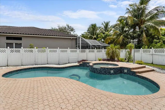 a view of a backyard with swimming pool