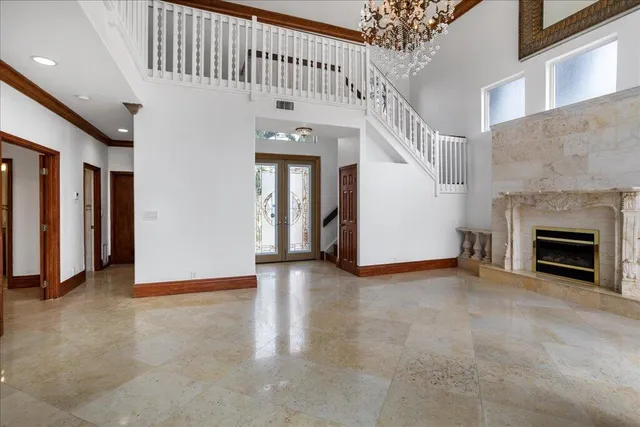 a view of a livingroom with an empty space and a fireplace