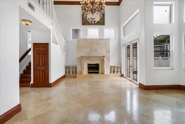 a view of an empty room with window and fireplace