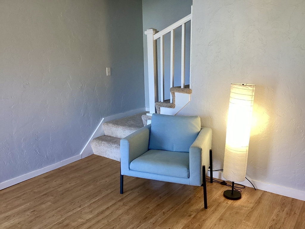 300 Falmouth Road, Unit 6B Mashpee, MA 02649 - Photo 12 of 27 a view of a hallway with wooden floor and chair