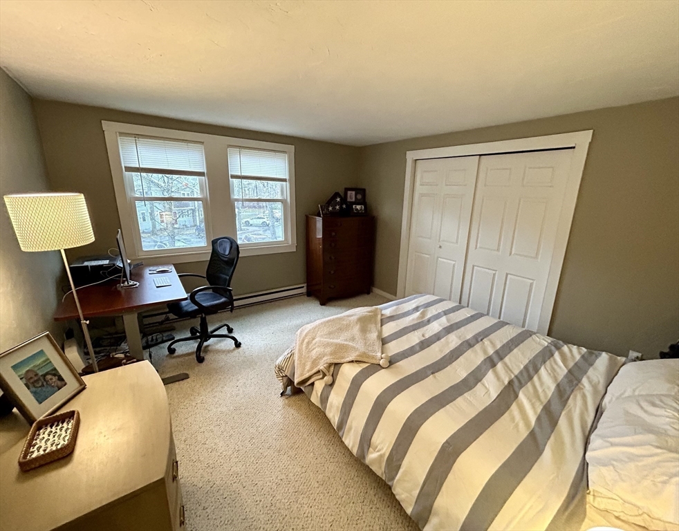 300 Falmouth Road, Unit 6B Mashpee, MA 02649 - Photo 15 of 27 a bedroom with a bed a chair and a large window