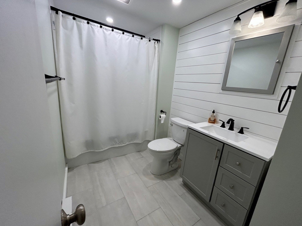 300 Falmouth Road, Unit 6B Mashpee, MA 02649 - Photo 19 of 27 a bathroom with a sink a toilet and shower