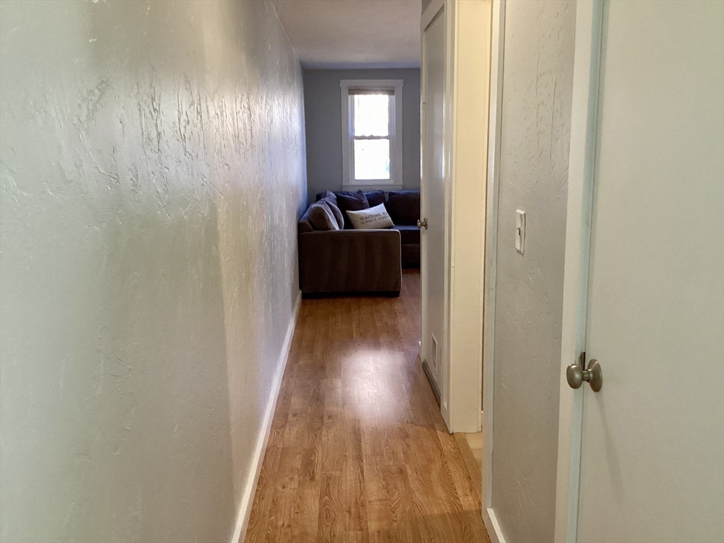 300 Falmouth Road, Unit 6B Mashpee, MA 02649 - Photo 7 of 27 a view of a hallway with wooden floor and stairs