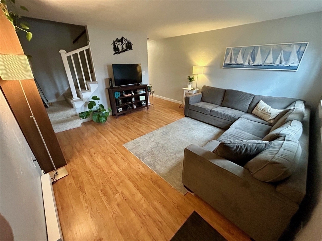 300 Falmouth Road, Unit 6B Mashpee, MA 02649 - Photo 8 of 27 a living room with furniture and a flat screen tv