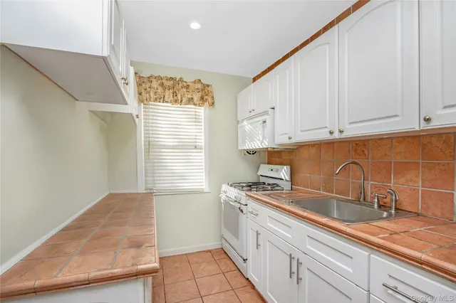 a kitchen with a sink cabinets and window