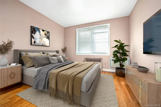 a bed room with bed and a potted plant