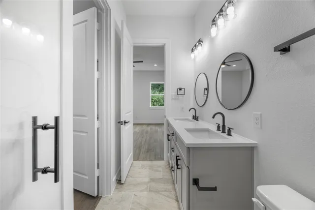 a bathroom with a toilet sink and mirror