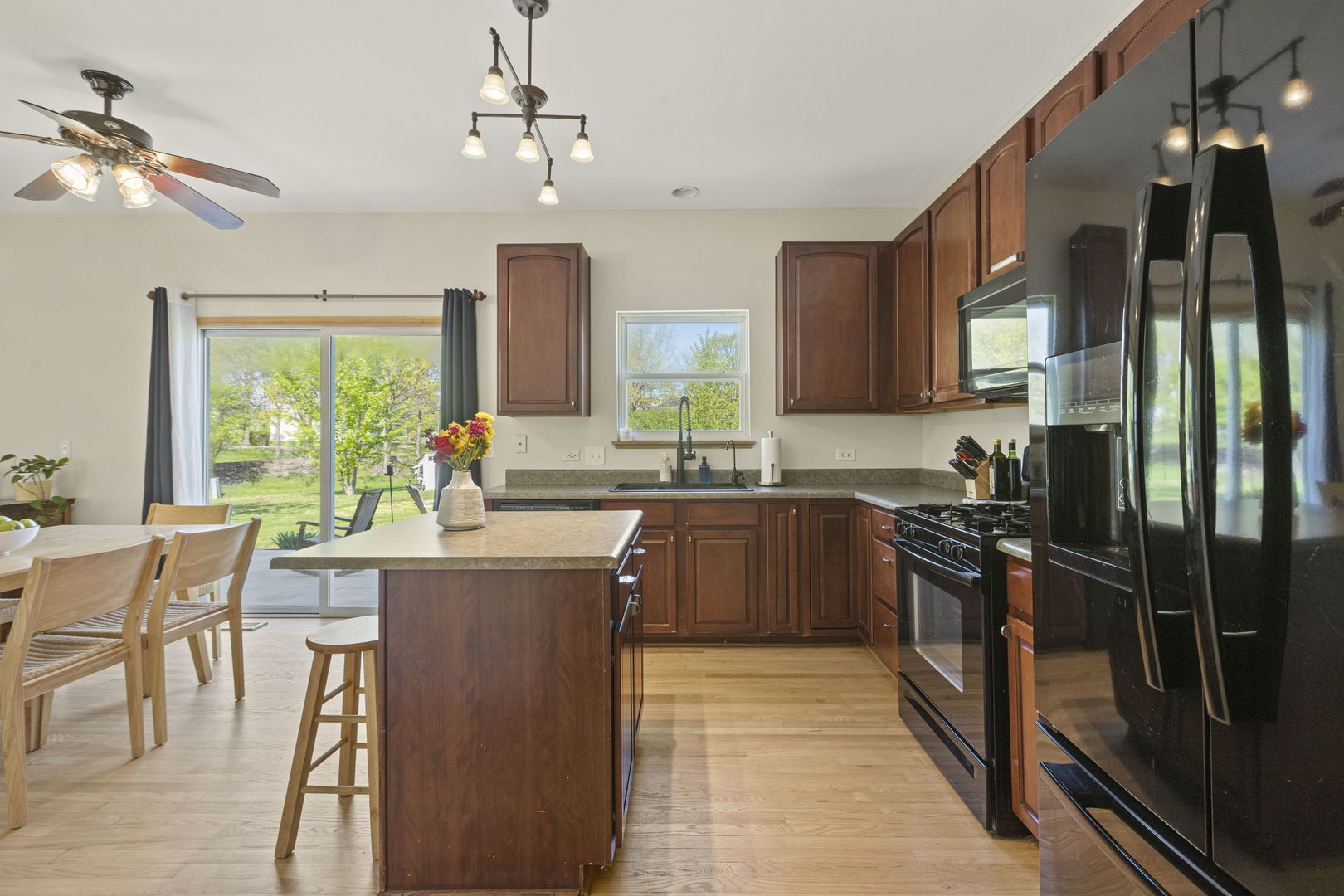 223 Aspen Circle Gilberts, IL 60136 - Photo 6 of 18 a kitchen with stainless steel appliances granite countertop sink stove top oven and cabinets
