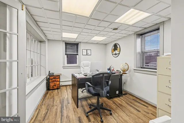 a workspace with table chair and a window
