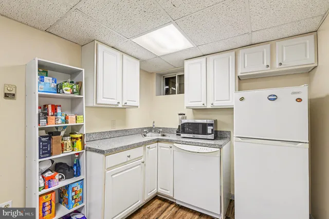 a kitchen with stainless steel appliances granite countertop a refrigerator sink and cabinets