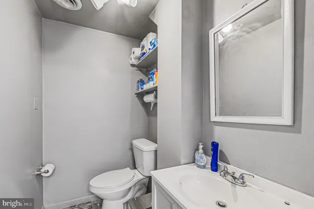 a white toilet sitting next to a bathroom sink