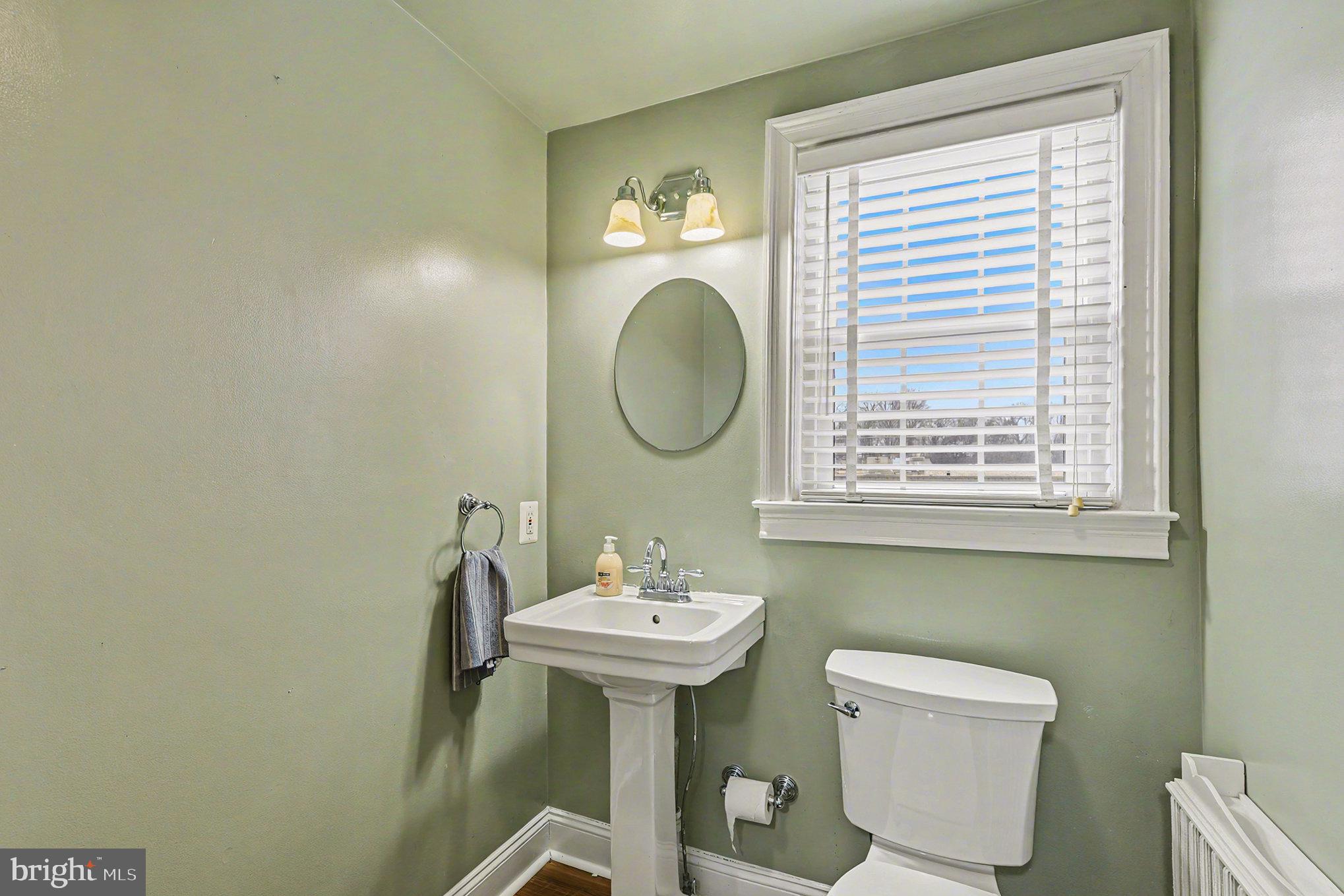 1424 East Joppa Road Baltimore, MD 21286 - Photo 18 of 30 a bathroom with a toilet a sink and a mirror