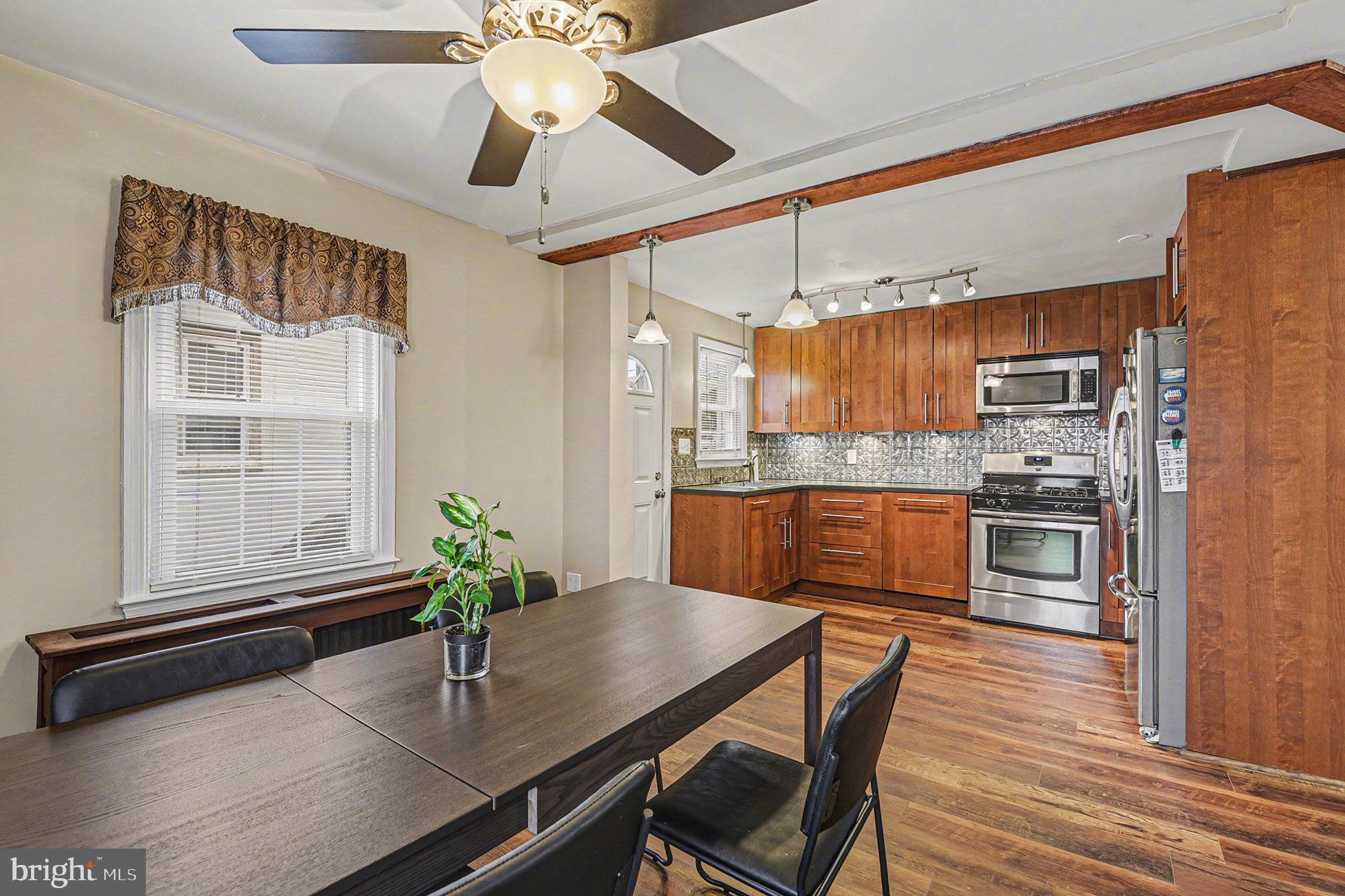 1424 East Joppa Road Baltimore, MD 21286 - Photo 7 of 30 a kitchen with a table chairs refrigerator and microwave