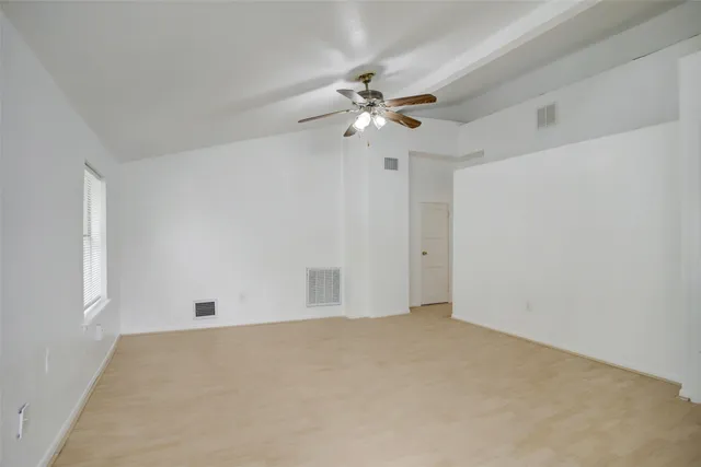 a kitchen with stainless steel appliances granite countertop a stove a sink and a refrigerator with white cabinets