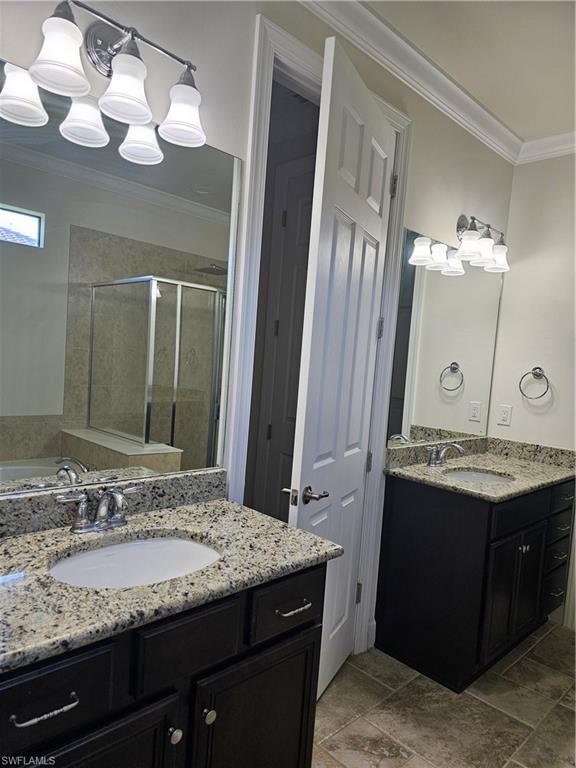 10840 Rutherford Road Fort Myers, FL 33913 - Photo 14 of 35 Bathroom featuring double vanity, crown molding, shower with separate bathtub, and tile patterned floors