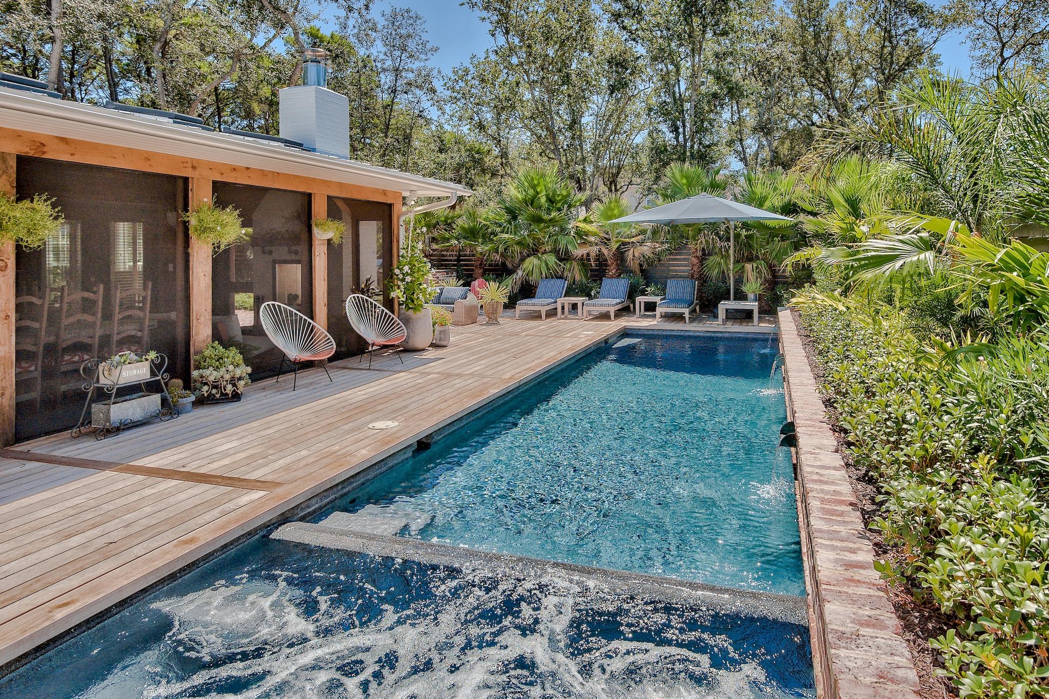 102 Camp Creek Road South Inlet Beach, FL 32461 - Photo 50 of 58 a view of a patio with table and chairs under an umbrella