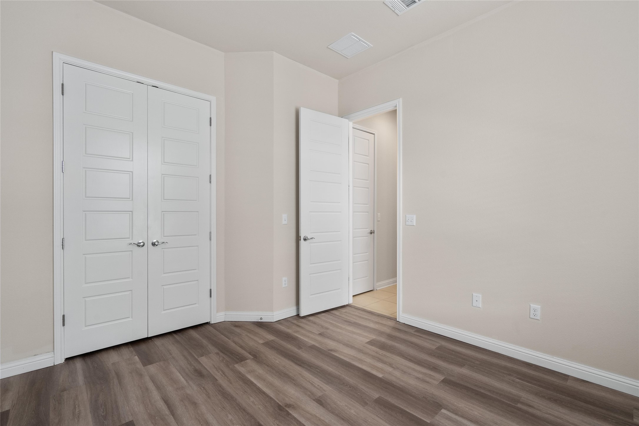 6907 Idea Road Austin, TX 78741 - Photo 11 of 36 a view of an empty room with closet and wooden floor