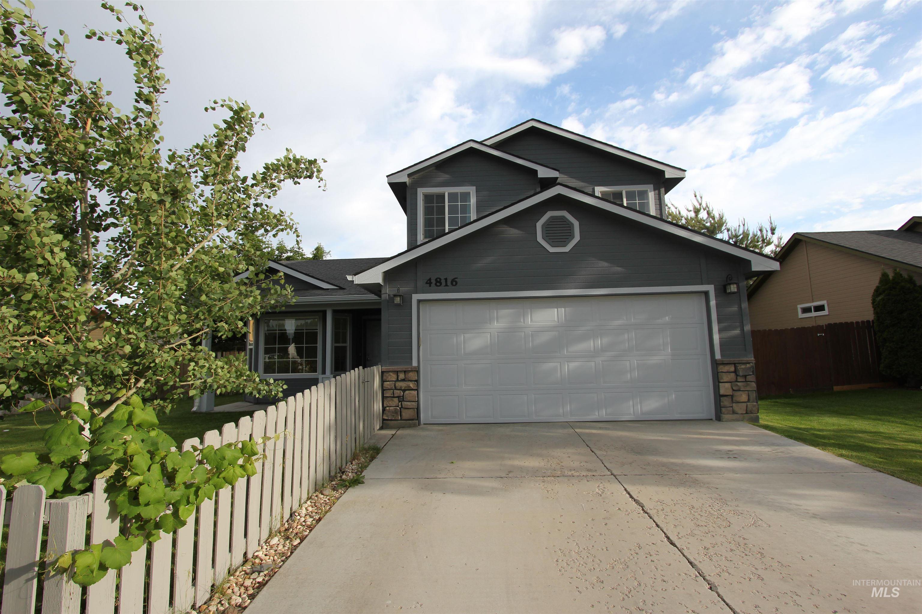 4816 Kadie Street Caldwell, ID 83607 - Photo 2 of 23 Contemporary gray two-story residence featuring a prominent attached garage with a light gray door