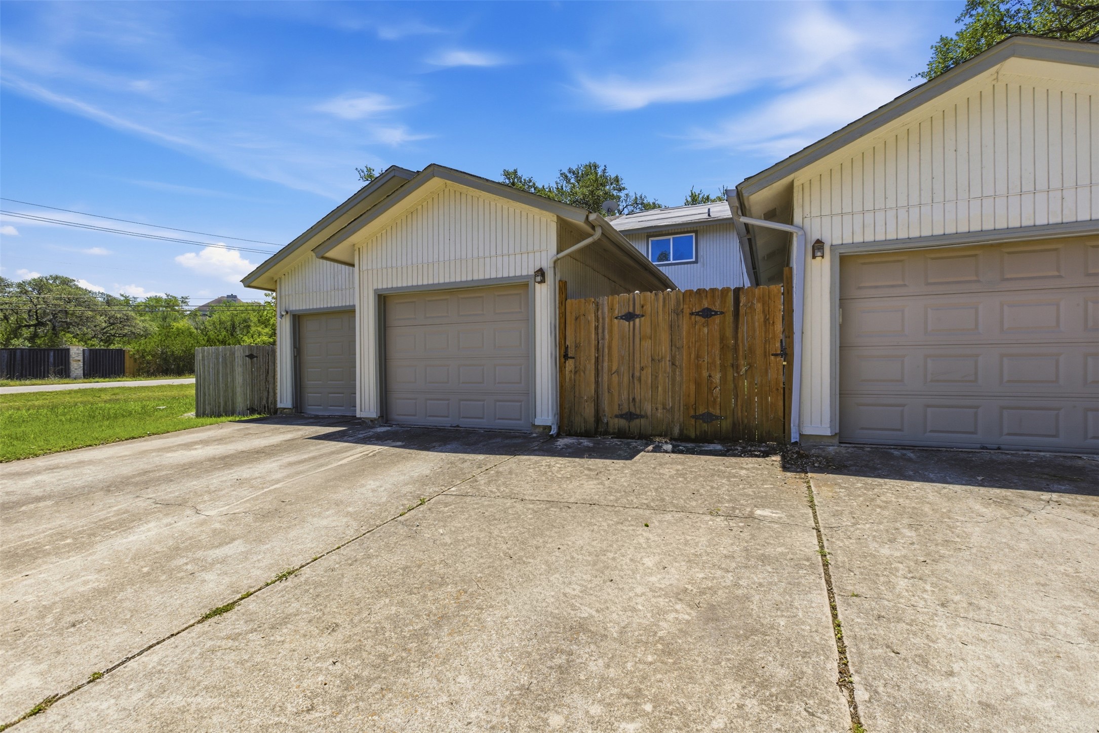 4204 Hudson Bend Road, Unit B Austin, TX 78734 - Photo 34 of 37 Exterior featuring multiple garage doors and a concrete driveway