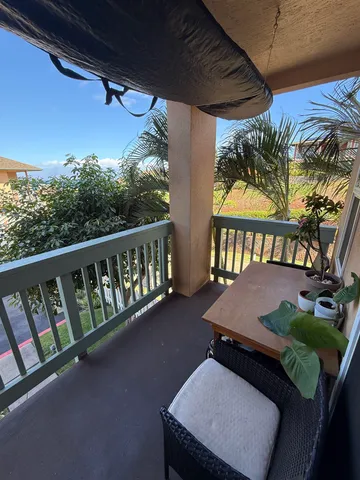 a balcony with furniture and a potted plant