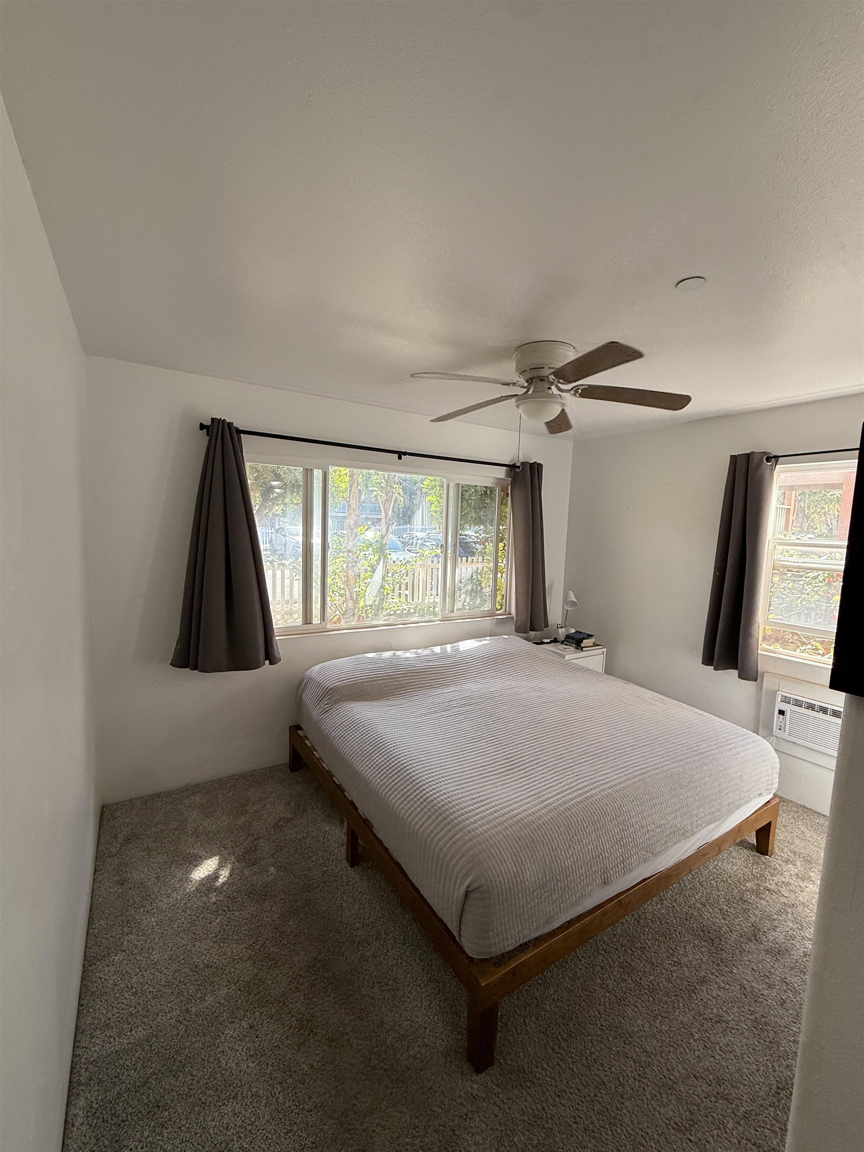 15 Abbey Lane, Unit 423 Lahaina, HI 96761 - Photo 2 of 7 a bed sitting in a room next to a window