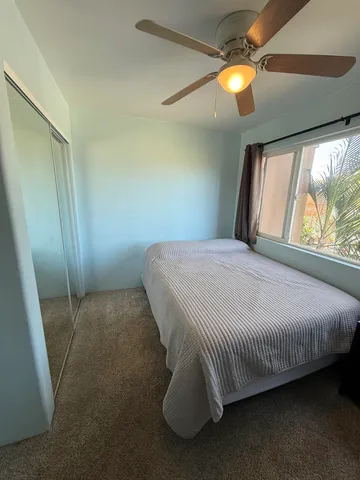 a bed sitting in a room next to a window