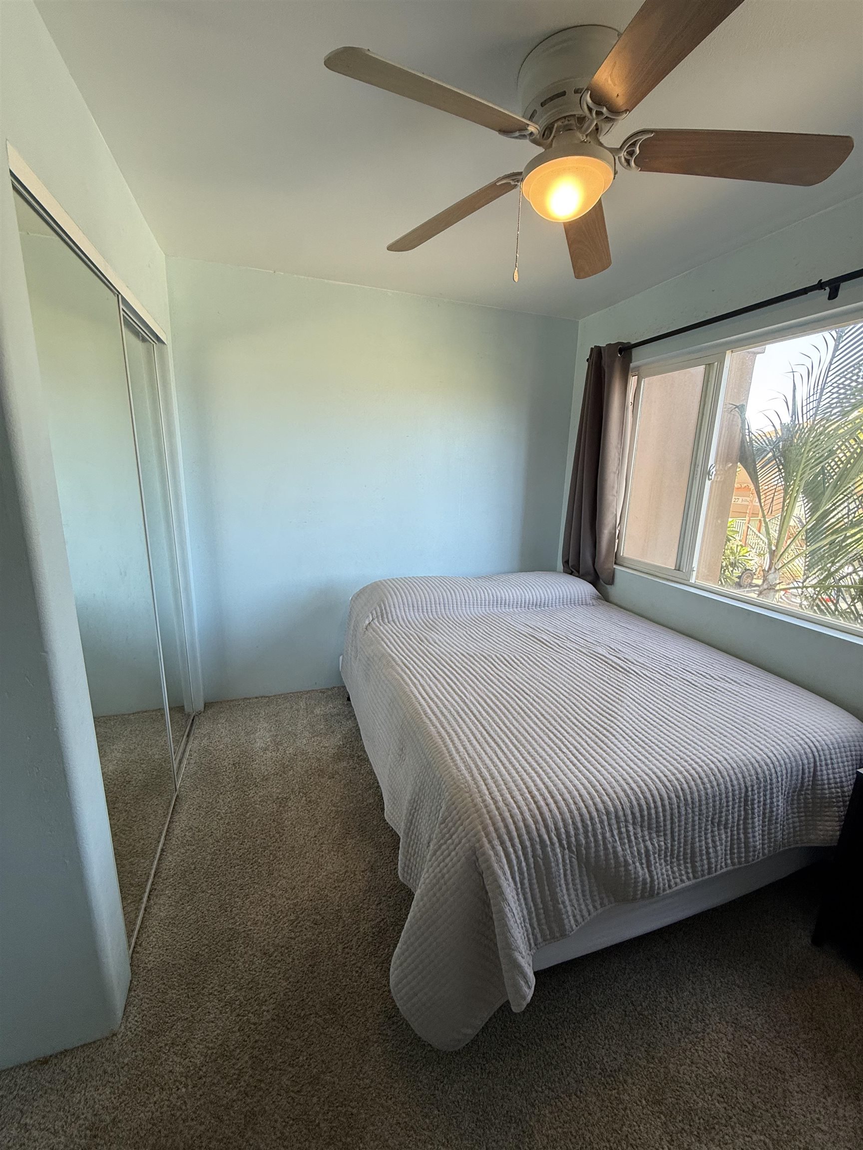 15 Abbey Lane, Unit 423 Lahaina, HI 96761 - Photo 6 of 7 a bed sitting in a room next to a window