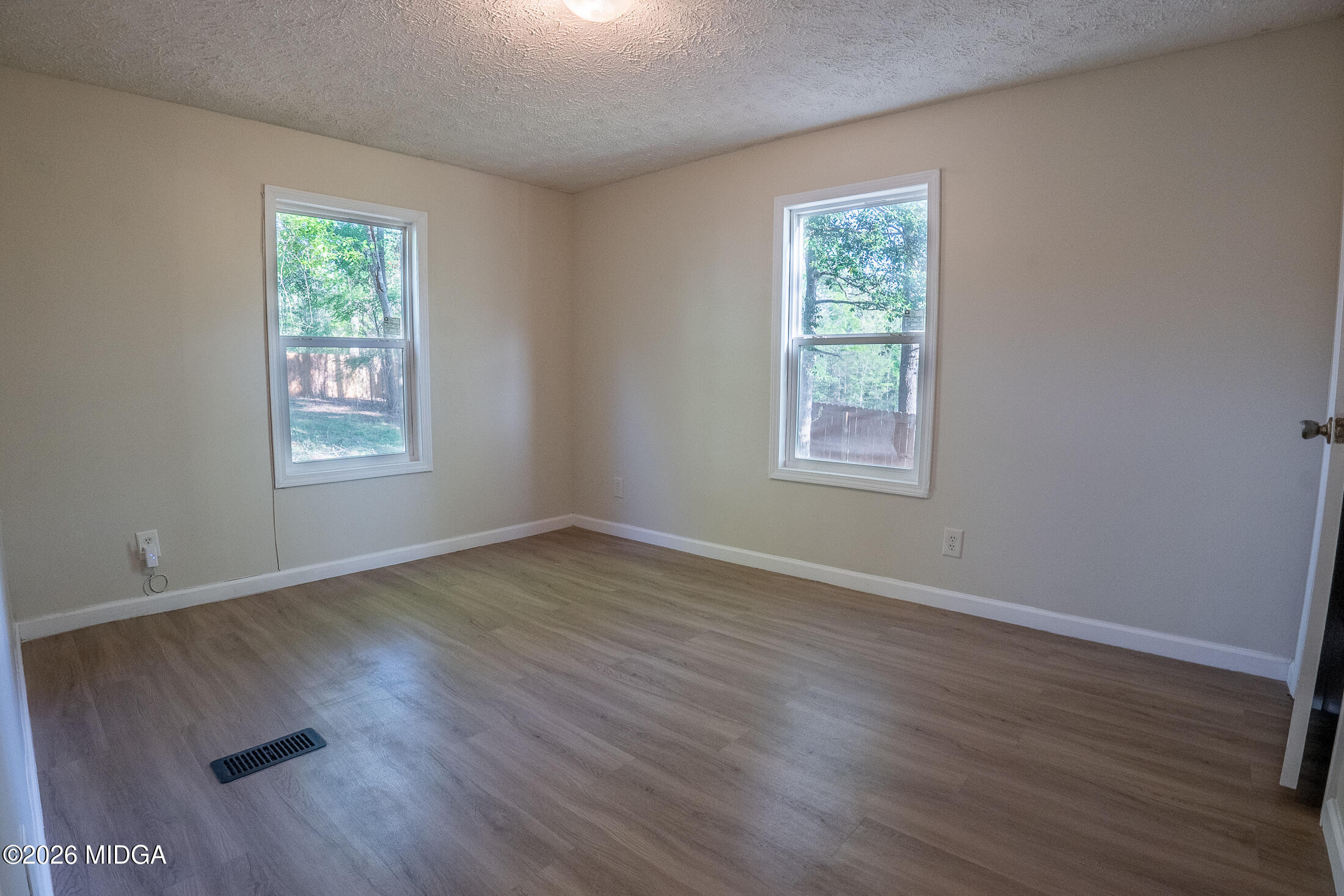 156 Alpine Drive Macon, GA 31206 - Photo 11 of 18 a view of an empty room with wooden floor and a window