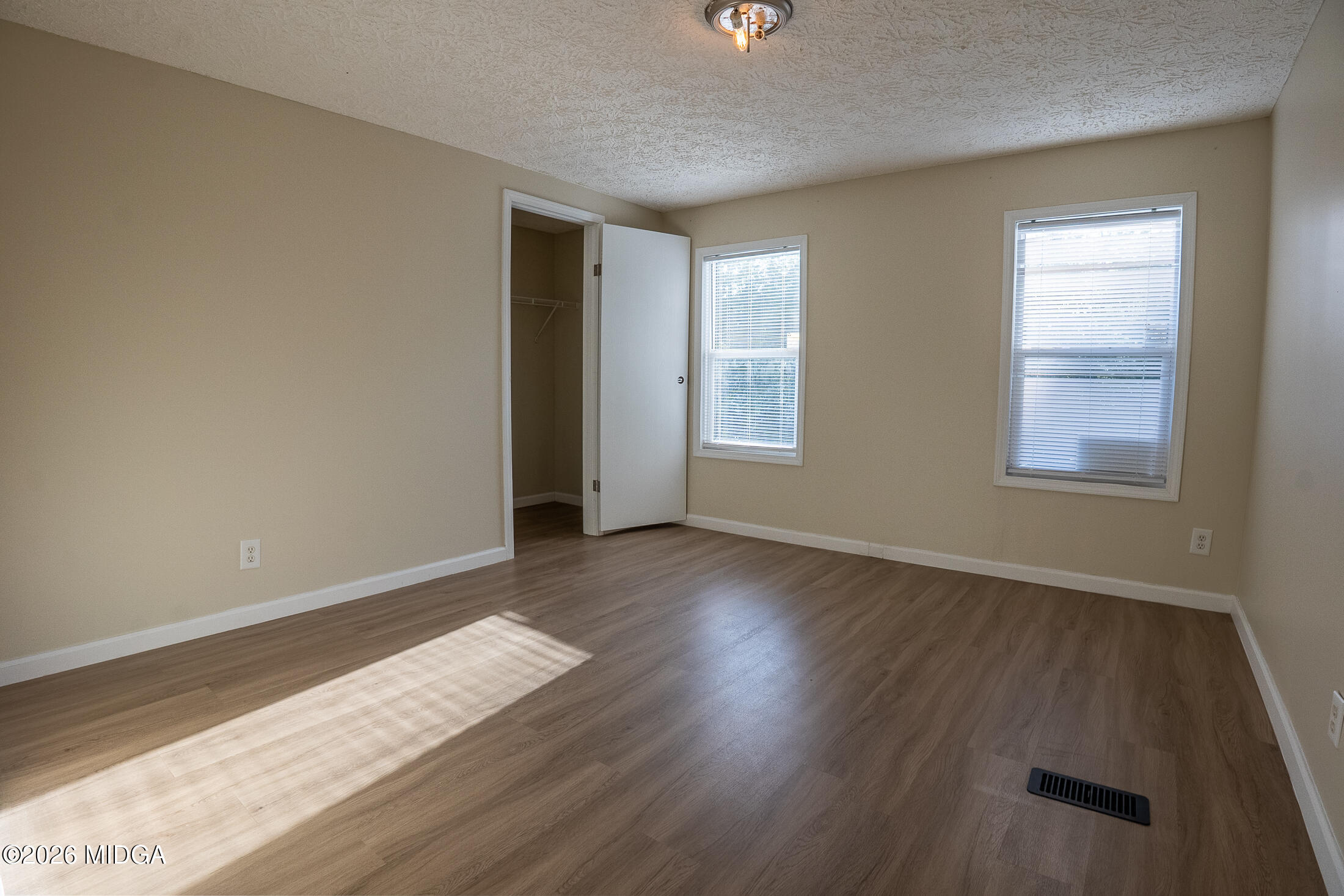 156 Alpine Drive Macon, GA 31206 - Photo 12 of 18 an empty room with wooden floor and windows