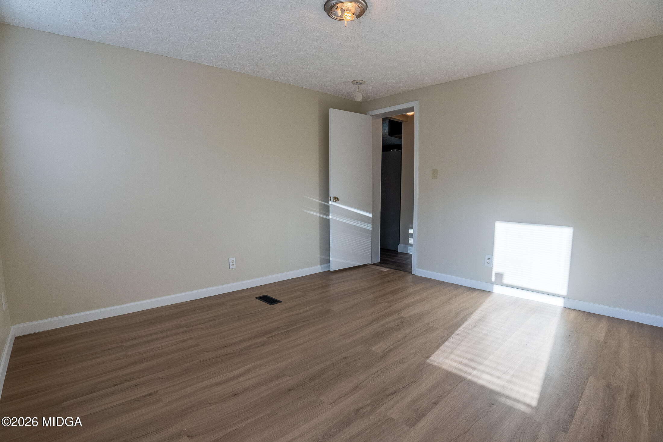 156 Alpine Drive Macon, GA 31206 - Photo 13 of 18 a view of an empty room with wooden floor and a window