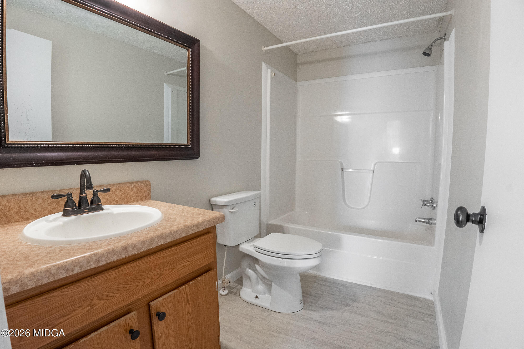 156 Alpine Drive Macon, GA 31206 - Photo 14 of 18 a bathroom with a sink toilet a mirror and shower