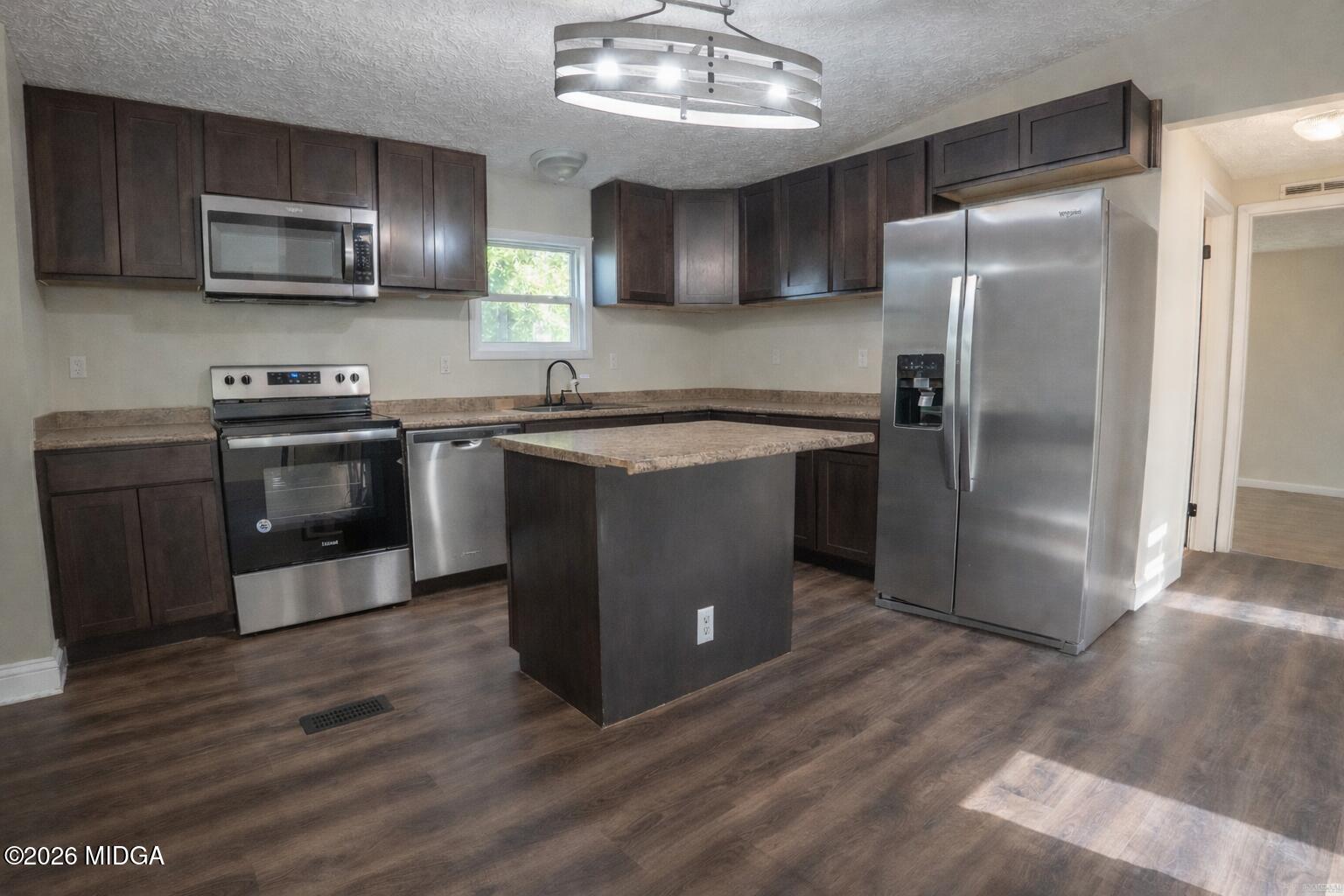 156 Alpine Drive Macon, GA 31206 - Photo 3 of 18 a kitchen with stainless steel appliances granite countertop a refrigerator a stove a sink and a microwave