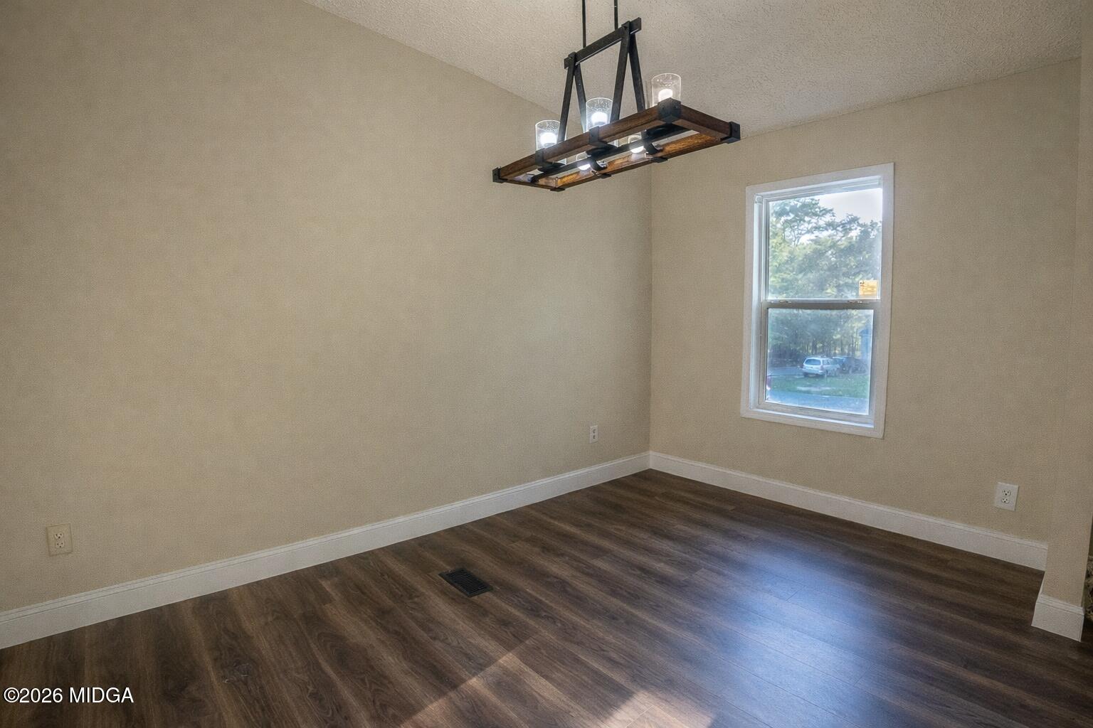 156 Alpine Drive Macon, GA 31206 - Photo 5 of 18 a view of an empty room with wooden floor and a window