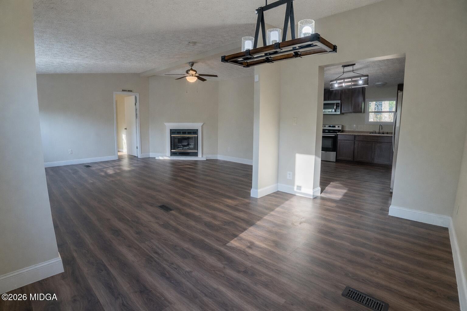 156 Alpine Drive Macon, GA 31206 - Photo 6 of 18 a view of a hallway with wooden floor and a kitchen