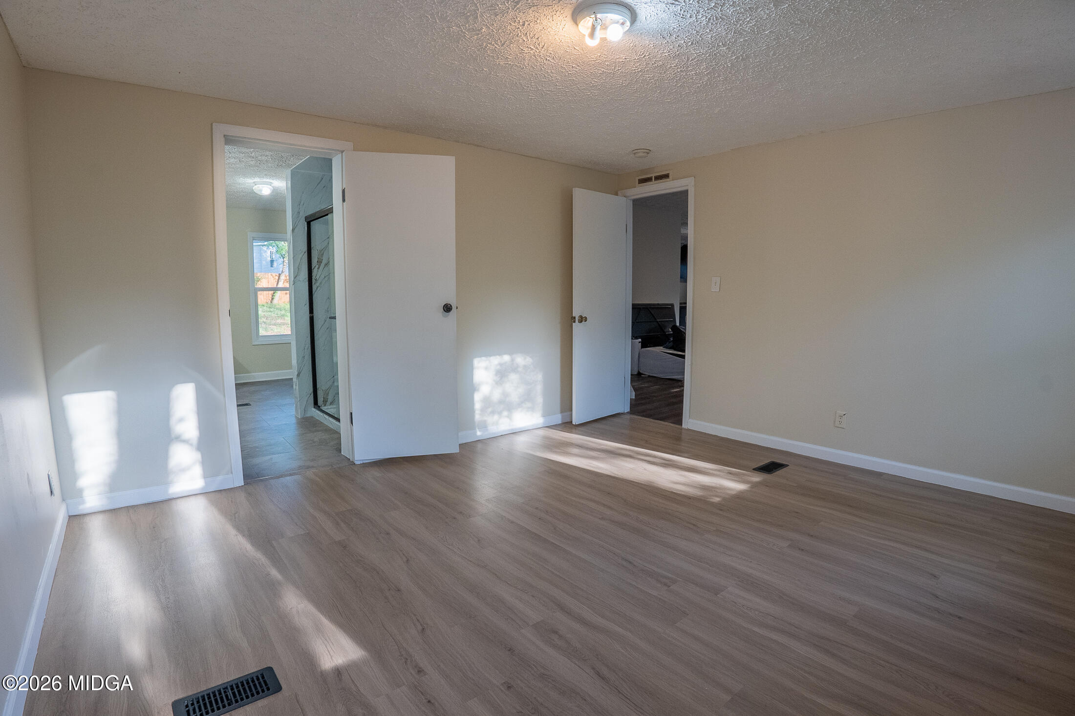 156 Alpine Drive Macon, GA 31206 - Photo 8 of 18 a view of an empty room with wooden floor and a window