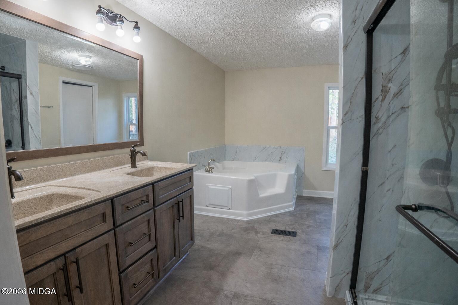 156 Alpine Drive Macon, GA 31206 - Photo 9 of 18 a bathroom with a double vanity sink mirror and bathtub