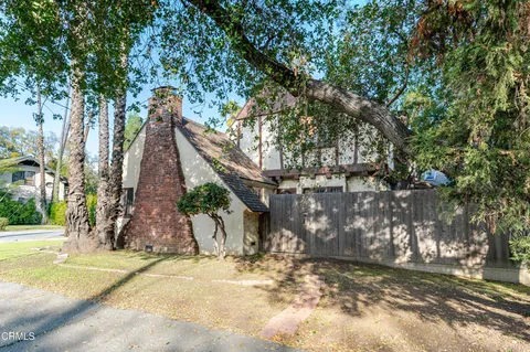 a view of a grey house with a yard