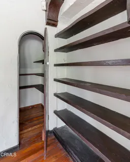 a view of empty room with fireplace and wooden floor