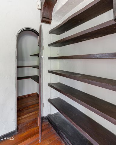 a view of empty room with fireplace and wooden floor
