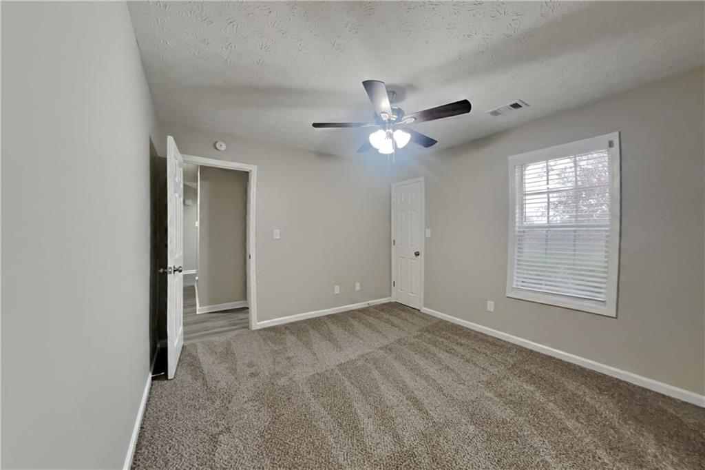 775 James Ridge Drive Lawrenceville, GA 30045 - Photo 13 of 19 an empty room with windows and fan
