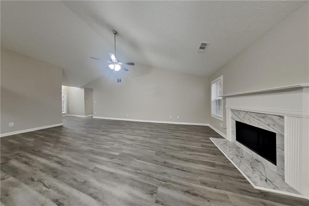 775 James Ridge Drive Lawrenceville, GA 30045 - Photo 3 of 19 a view of a livingroom with wooden floor and a fireplace