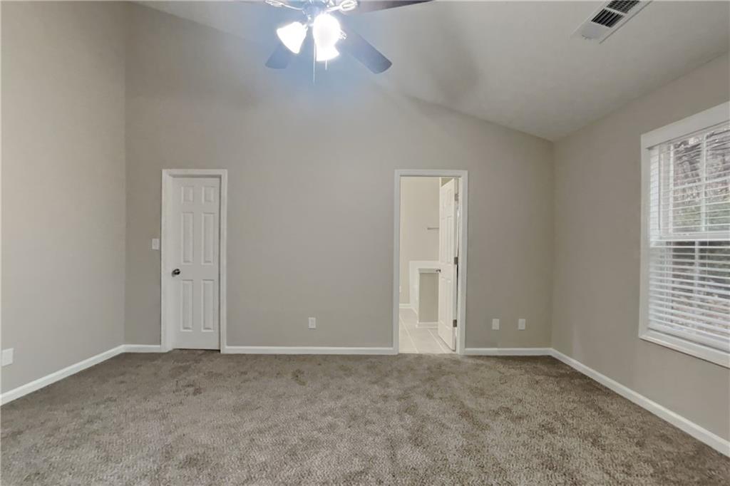 775 James Ridge Drive Lawrenceville, GA 30045 - Photo 8 of 19 an empty room with windows and chandelier fan