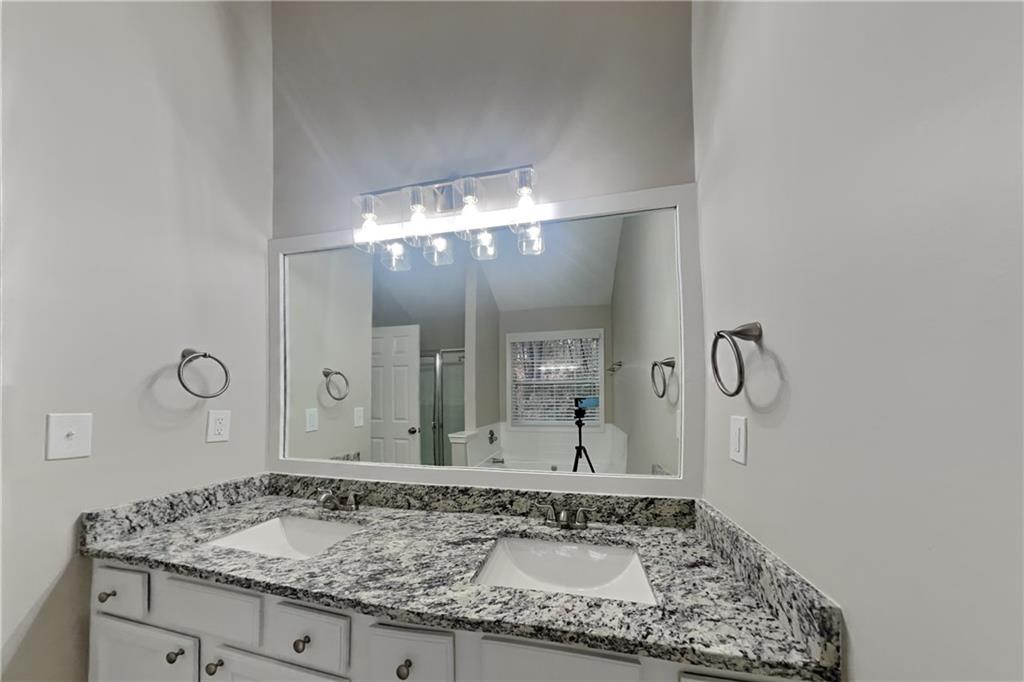 775 James Ridge Drive Lawrenceville, GA 30045 - Photo 9 of 19 a bathroom with a granite countertop sink and a mirror