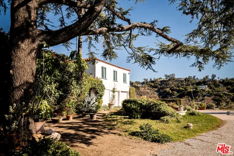 a view of a house with a tree and yard