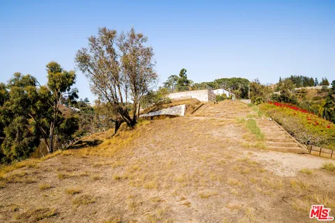 a view of a house with lot of flowers