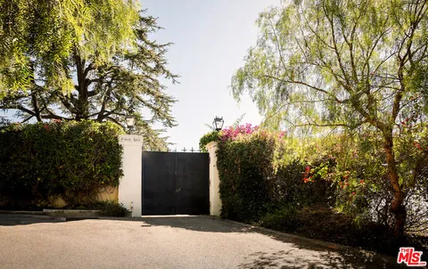a couple of flower plants in front of house